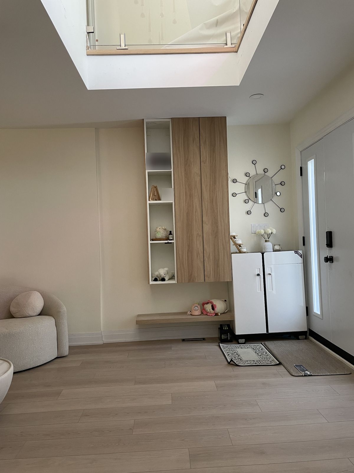 Entry with custom floating wall cabinet, glass railing and engineered hardwood in Scarborough